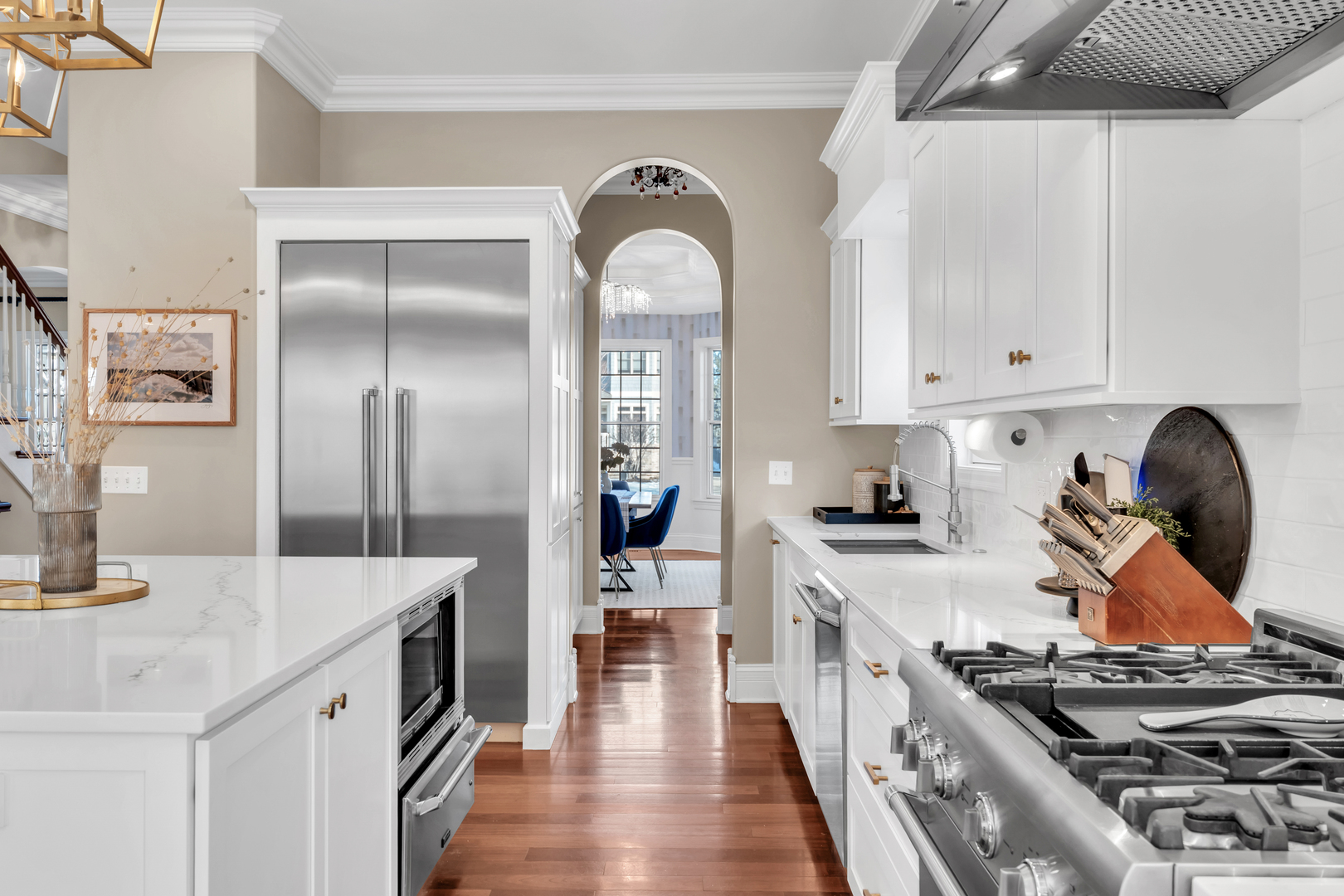 749 East Sunnyside Avenue Libertyville, IL 60048 - Photo 12 of 54 a kitchen with stainless steel appliances granite countertop a stove and a sink