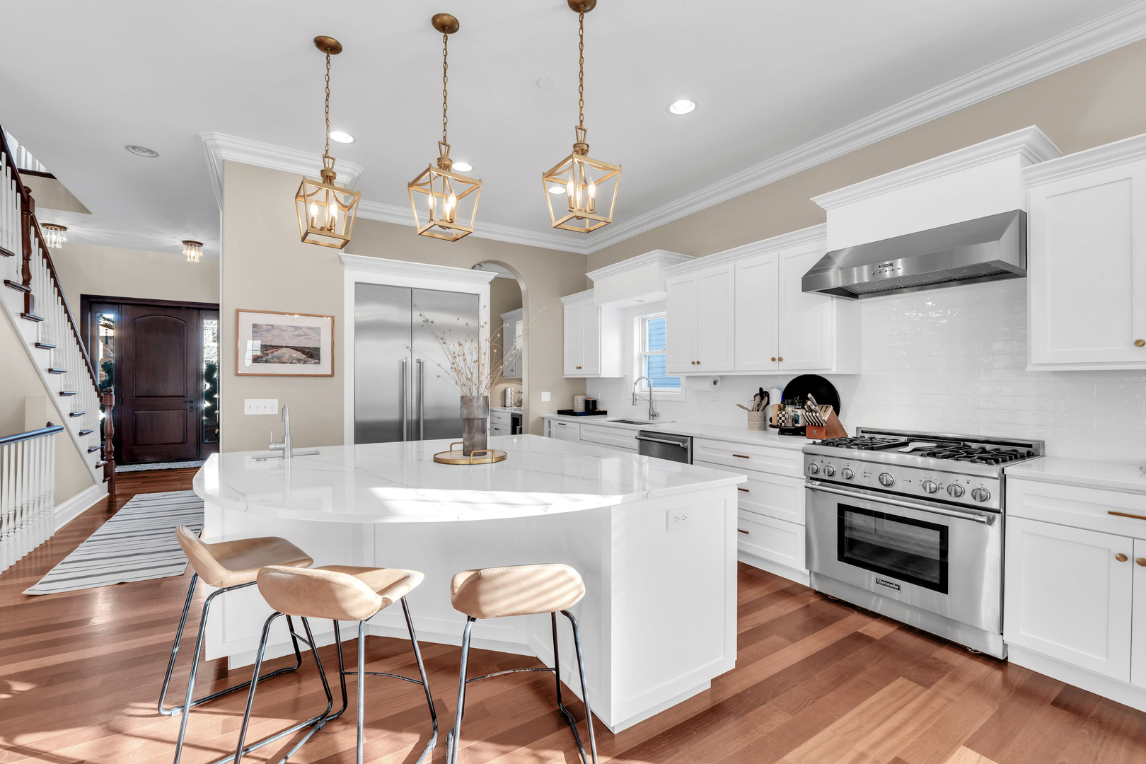 749 East Sunnyside Avenue Libertyville, IL 60048 - Photo 13 of 54 a large kitchen with stainless steel appliances granite countertop a stove a sink dishwasher a dining table and chairs with wooden floor