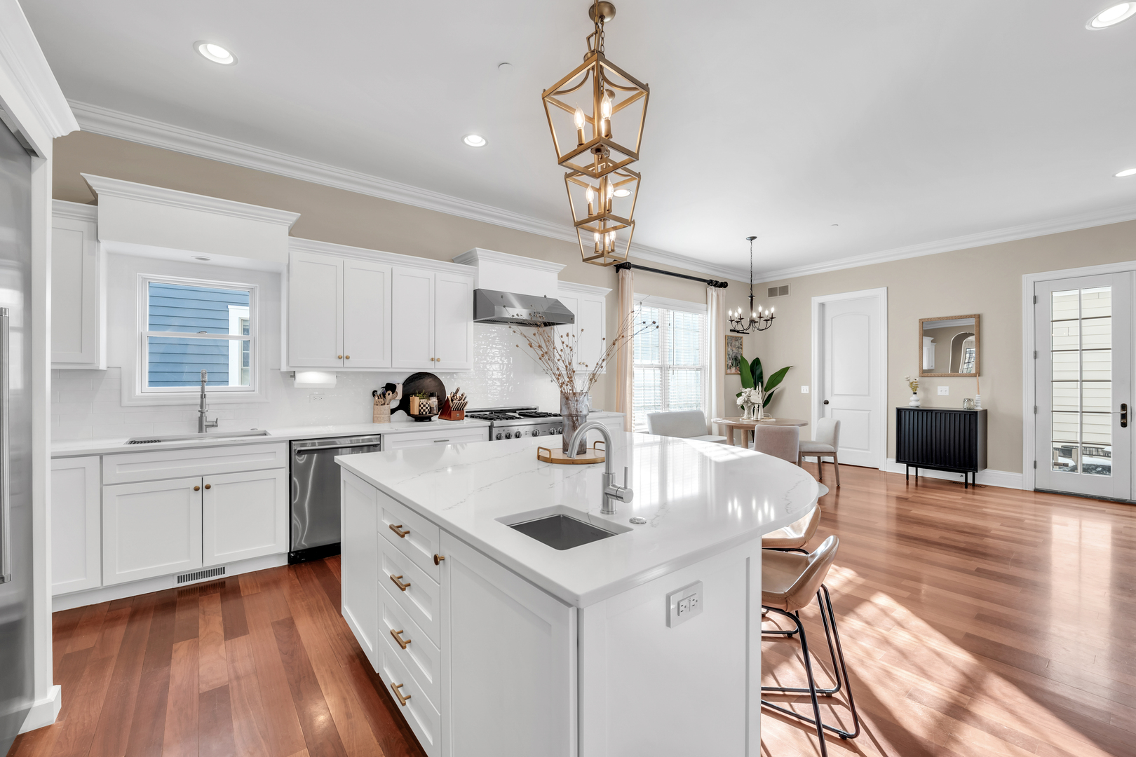 749 East Sunnyside Avenue Libertyville, IL 60048 - Photo 14 of 54 a kitchen with white cabinets appliances and wooden floor