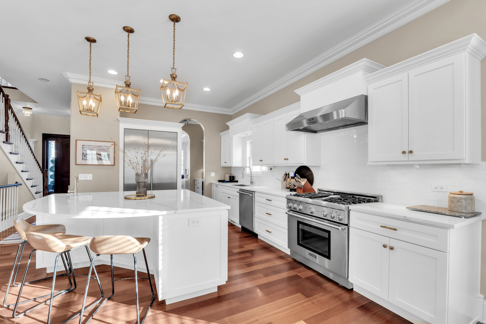 749 East Sunnyside Avenue Libertyville, IL 60048 - Photo 15 of 54 a large kitchen with stainless steel appliances kitchen island granite countertop a stove a sink a dining table and chairs with wooden floor