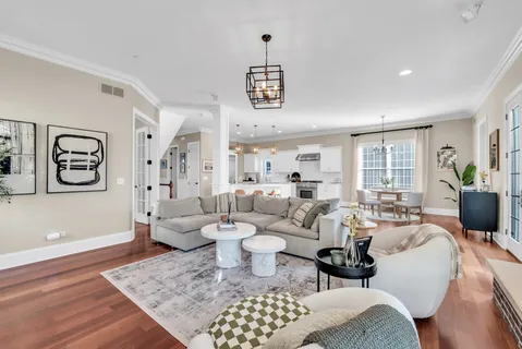 a living room with furniture kitchen view and a fireplace