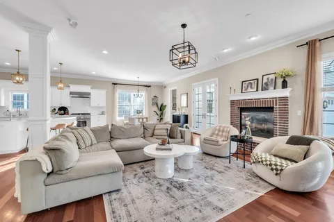 a living room with furniture a large window and a flat screen tv