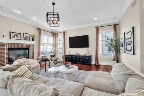 a living room with fireplace furniture and a flat screen tv