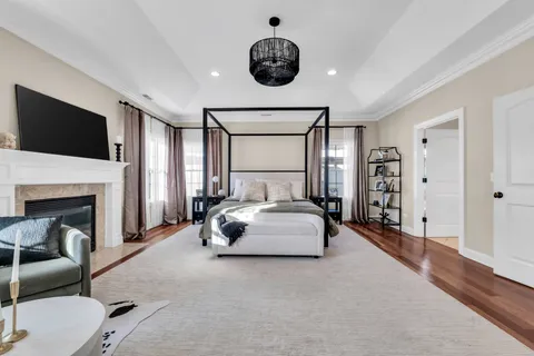 a bathroom with a tub a sink a mirror and a shower