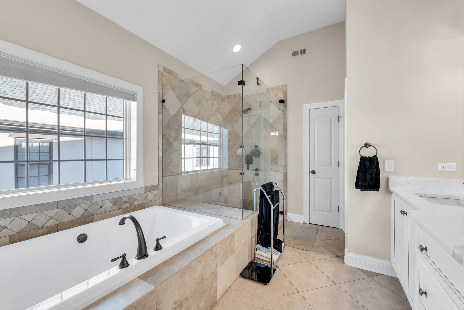 749 East Sunnyside Avenue Libertyville, IL 60048 - Photo 35 of 54 a bathroom with a tub a sink a mirror and a shower