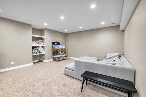 a room with furniture pool table and windows