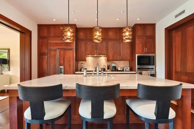 a kitchen with a dining table chairs and view kitchen