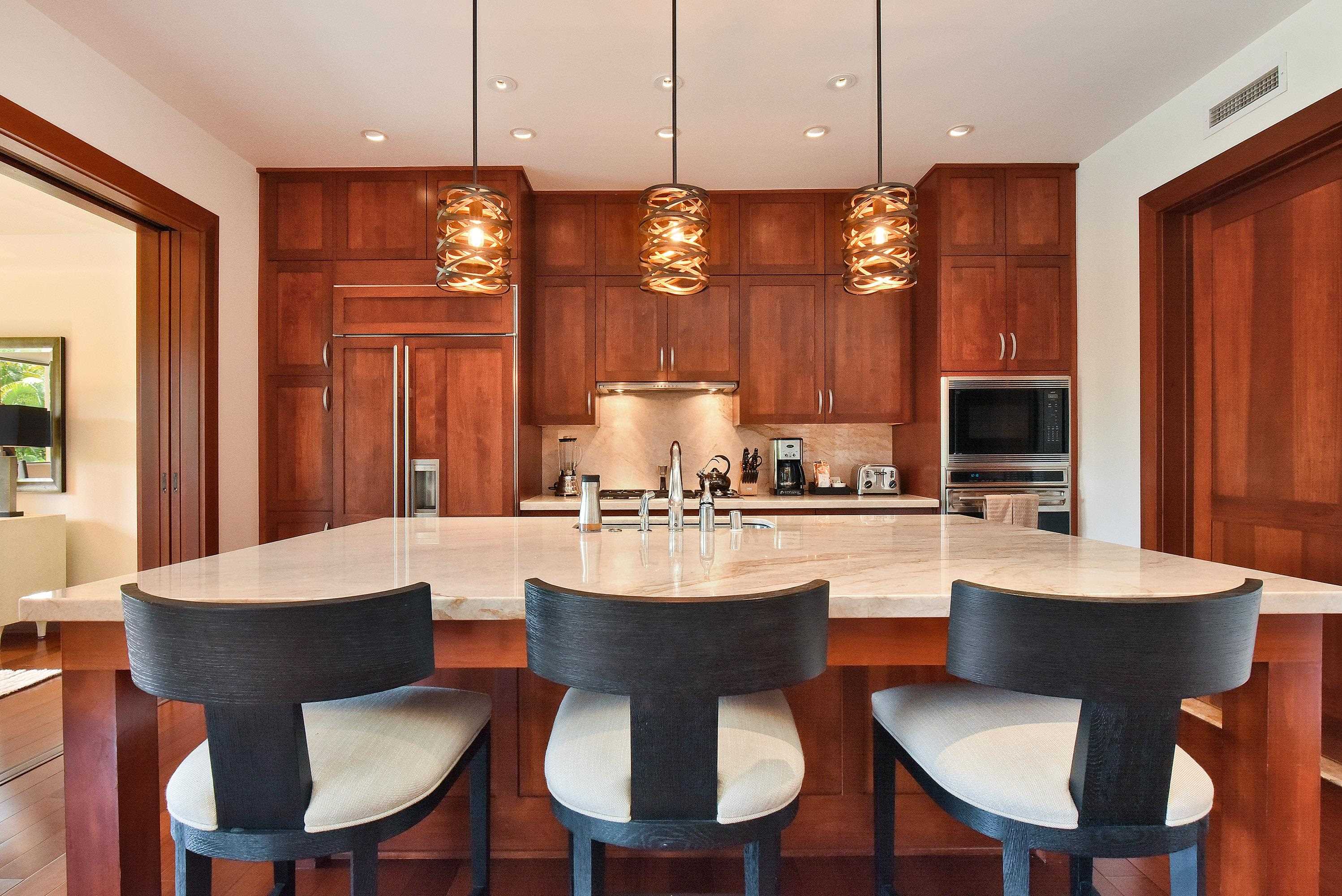 1 Bay Drive, Unit 5102 Lahaina, HI 96761 - Photo 12 of 50 a kitchen with a dining table chairs and view kitchen