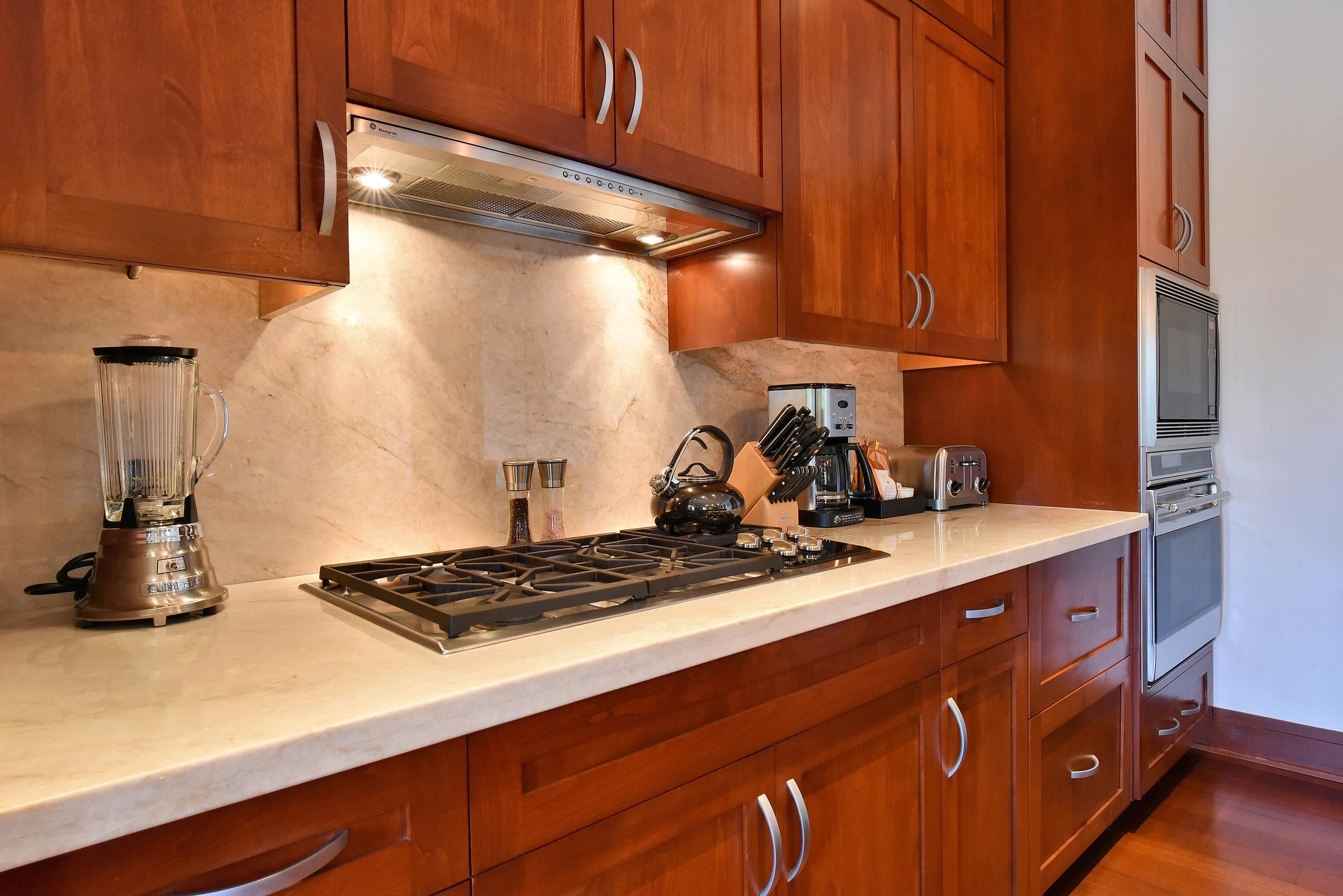 1 Bay Drive, Unit 5102 Lahaina, HI 96761 - Photo 13 of 50 a kitchen with stainless steel appliances granite countertop a sink stove and cabinets