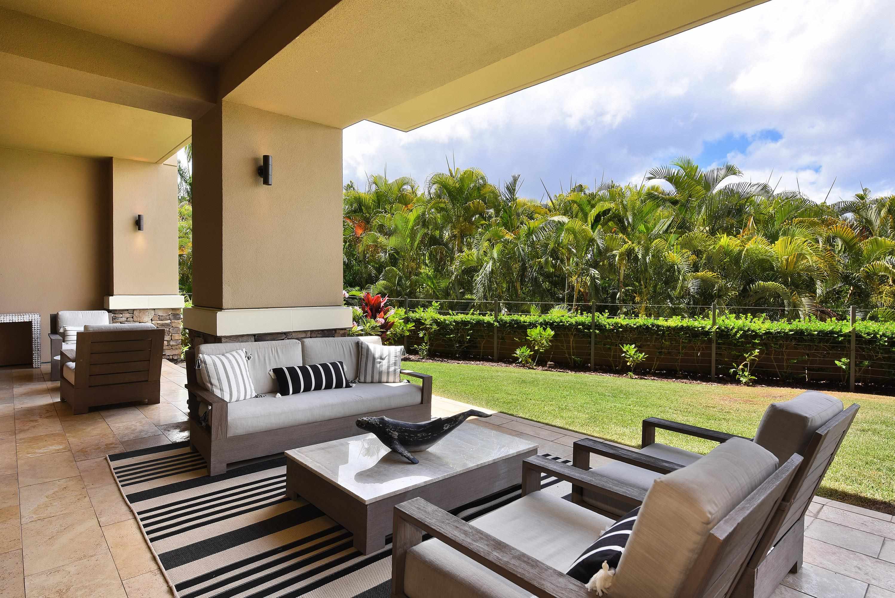 1 Bay Drive, Unit 5102 Lahaina, HI 96761 - Photo 38 of 50 a view of a patio with couches table and chairs with wooden floor and fence