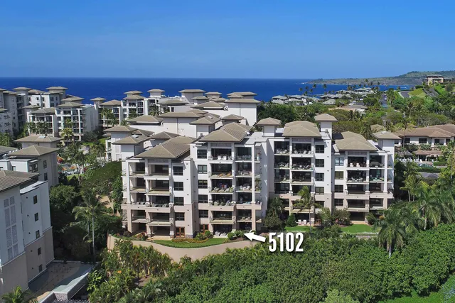 a view of a lake with couches and swimming pool