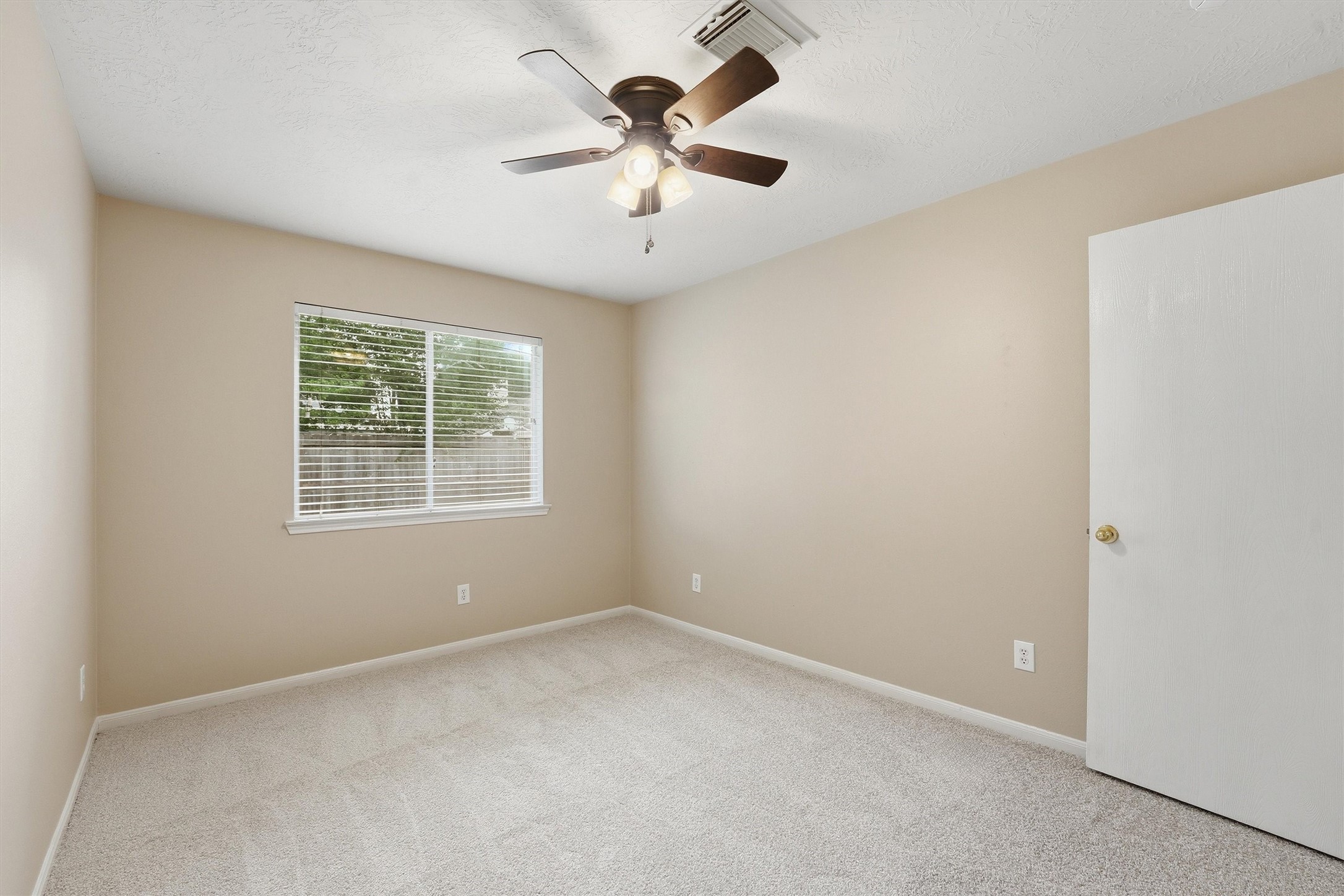 21543 Forest Colony Drive Porter, TX 77365 - Photo 19 of 32 Spacious primary bedroom with central lite and fan adjacent to full bath. bright and airy