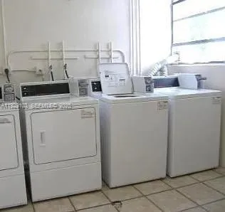 a view of washer and dryer with kitchen in the background