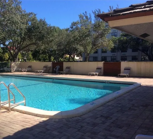 a view of a swimming pool with a yard