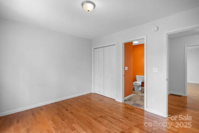 a view of an empty room and wooden floor