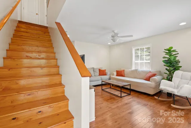 a living room with furniture and a stair