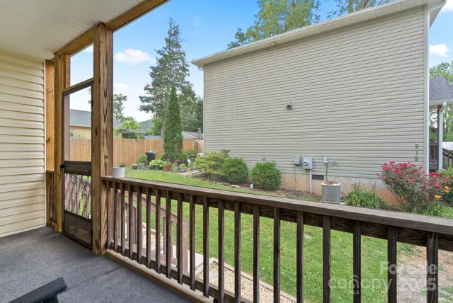a view of a balcony with flower plants