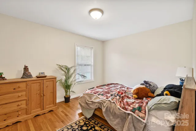 a bedroom with a bed and dresser with mirror