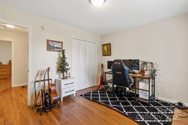 a view of a workspace with furniture and wooden floor