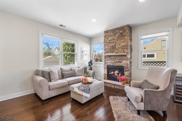 a living room with furniture fireplace and a large window