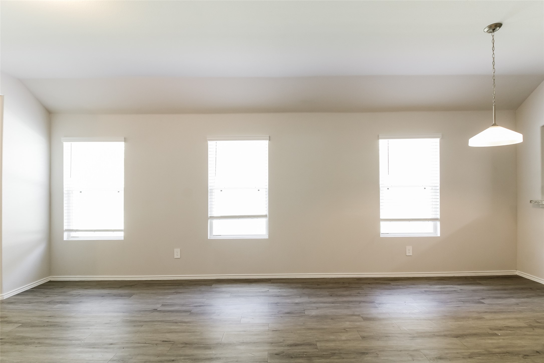 2528 Shad Drive Conroe, TX 77384 - Photo 4 of 16 an empty room with wooden floor and windows