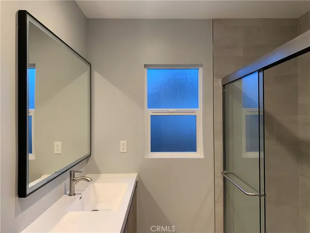 a bathroom with a sink and a large mirror