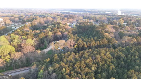 an aerial view of house with yard and mountain view in back