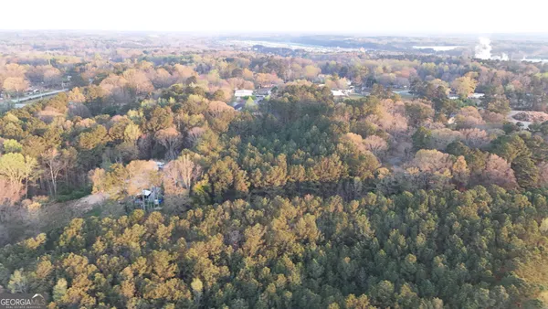 an aerial view of house with yard and mountain view in back