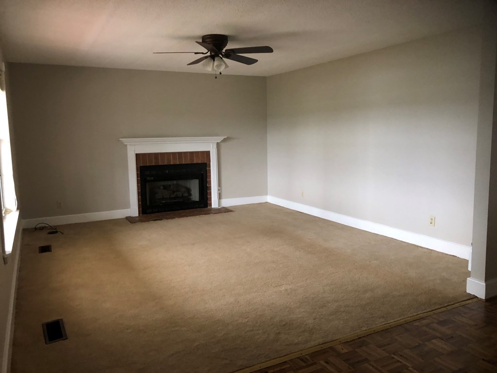 161 East Armuchee Road LaFayette, GA 30728 - Photo 6 of 20 an empty room with a fireplace and fan