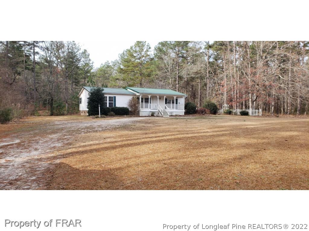272 Town Branch Road Vass, NC 28394 - Photo 1 of 20 a front view of a house with a yard