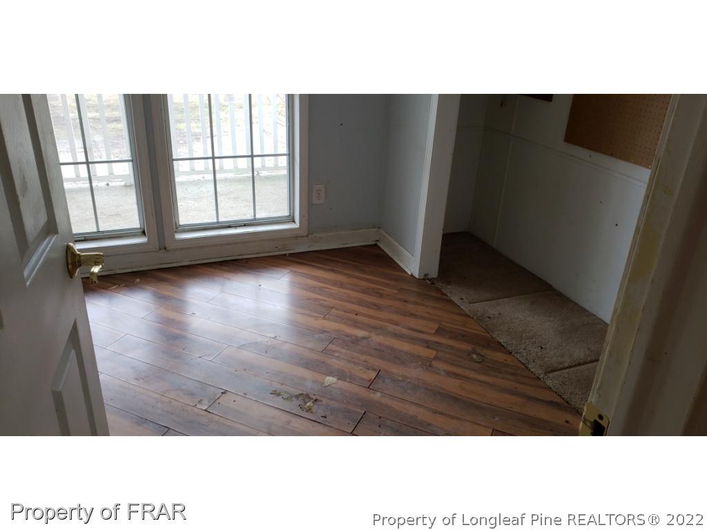 272 Town Branch Road Vass, NC 28394 - Photo 11 of 20 a view of an empty room with wooden floor