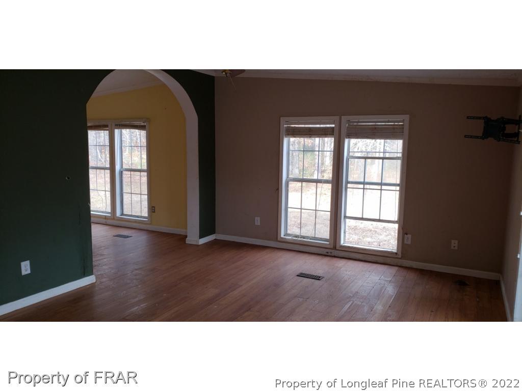 272 Town Branch Road Vass, NC 28394 - Photo 6 of 20 a view of an empty room with wooden floor and a window