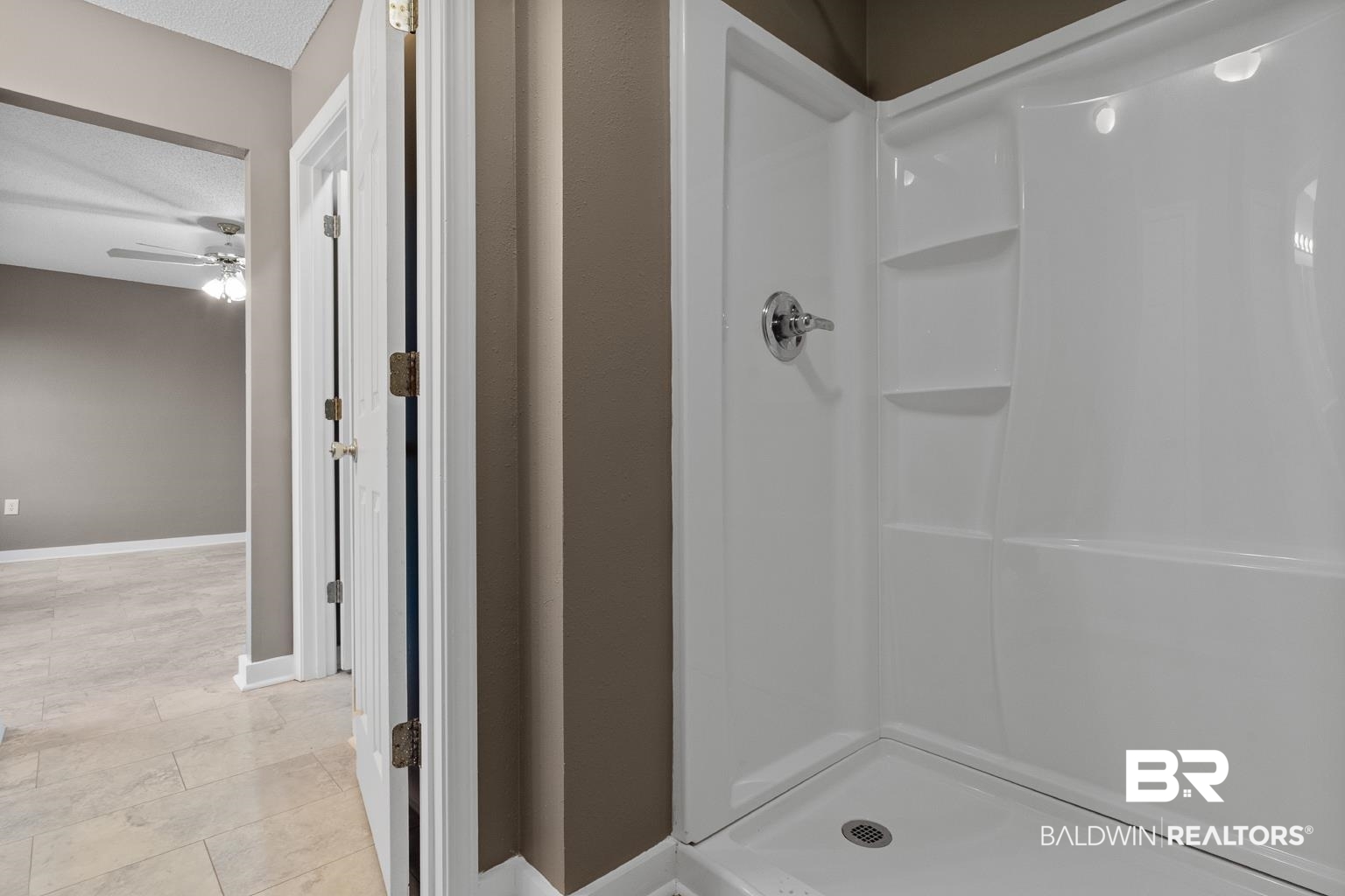 16418 Avent Lane Foley, AL 36535 - Photo 25 of 30 Bathroom with ceiling fan, a shower, tile patterned flooring, and a textured ceiling
