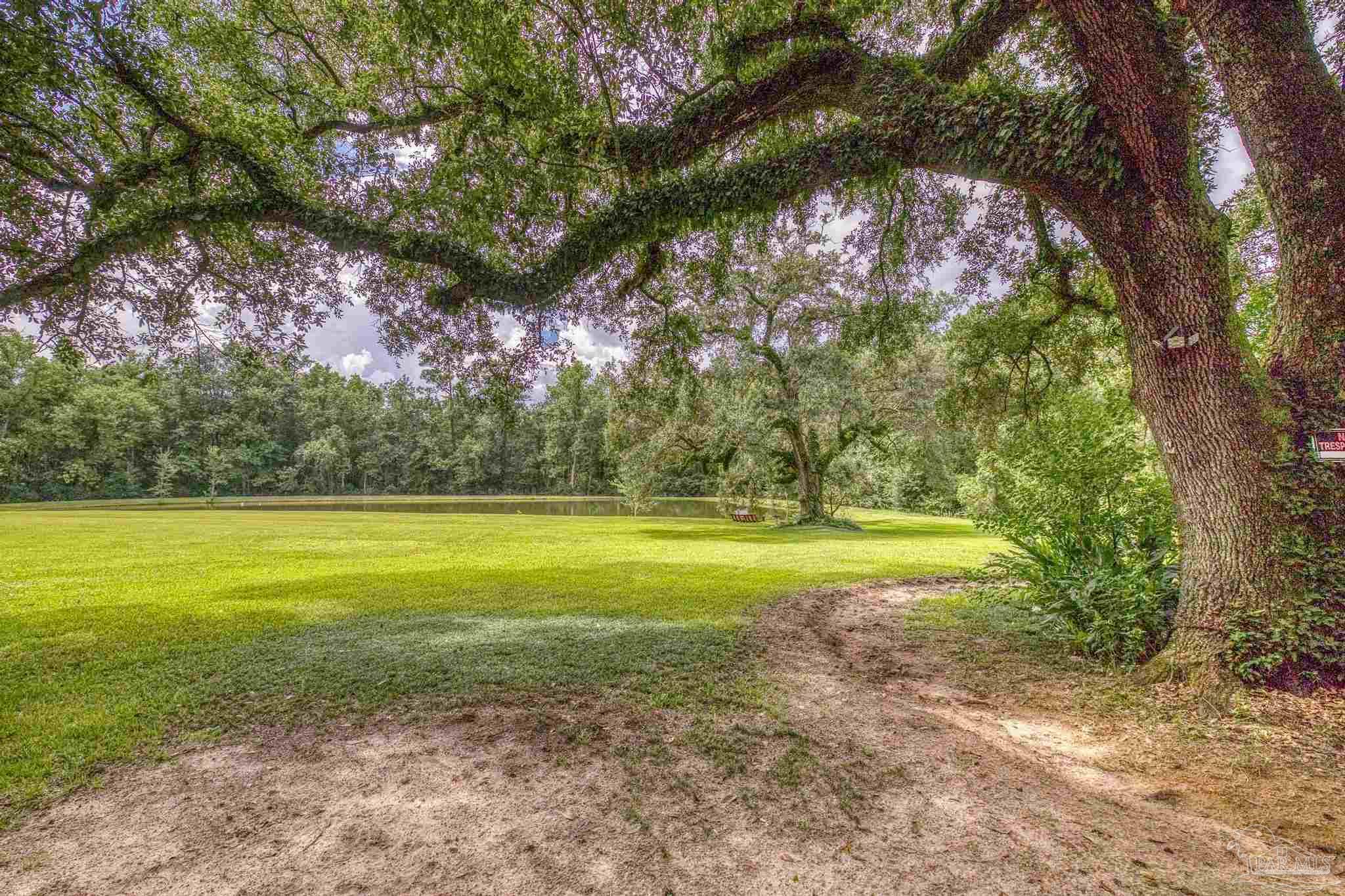 2345 Pompano Street Cantonment, FL 32533 - Photo 14 of 48 a view of a yard with swimming pool
