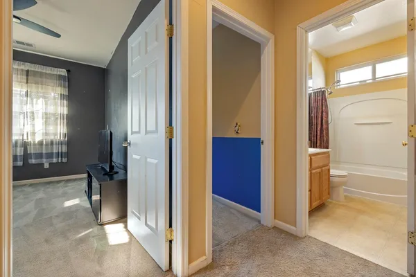 a view of a bathroom from a corridor
