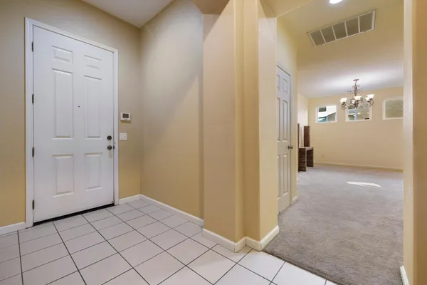 a view of a hallway to closet and a bathroom