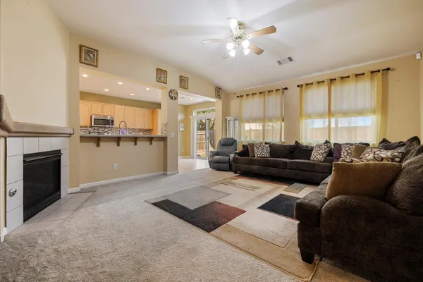 a living room with furniture fireplace and a large window