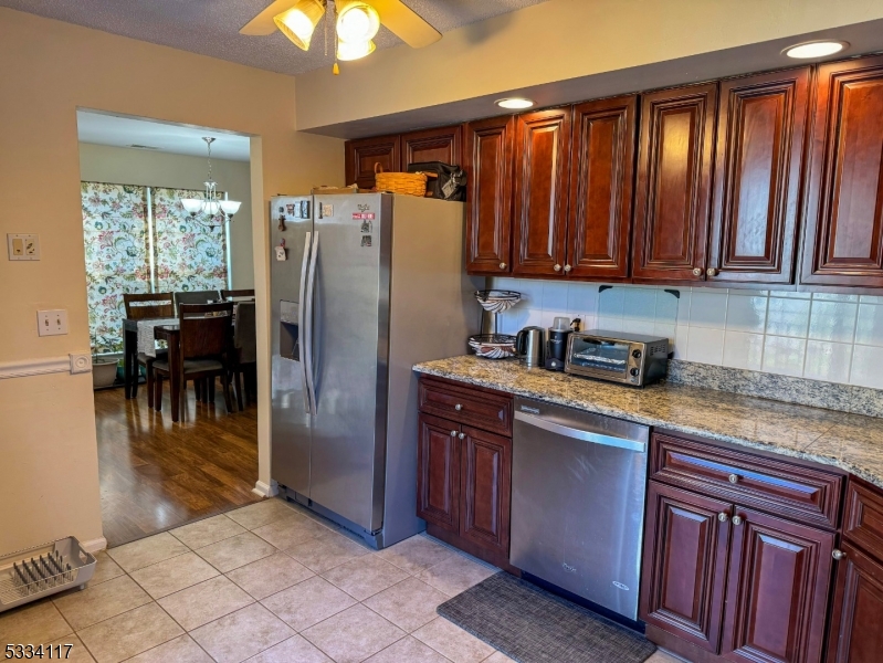 3206 French Drive Bridgewater, NJ 08807 - Photo 3 of 18 a kitchen with stainless steel appliances granite countertop a refrigerator a stove a sink and dishwasher