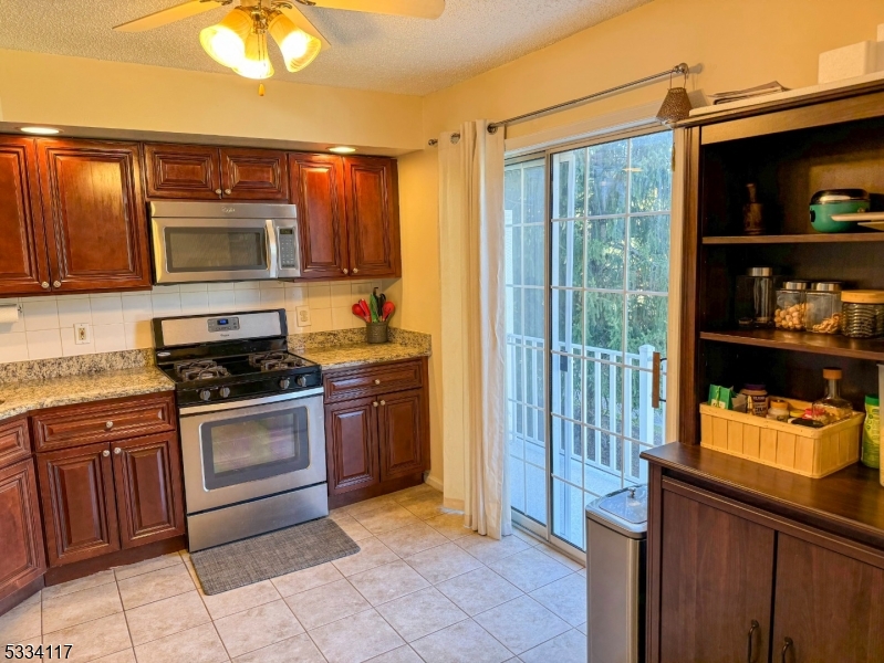 3206 French Drive Bridgewater, NJ 08807 - Photo 5 of 18 a kitchen with stainless steel appliances granite countertop a stove sink and cabinets