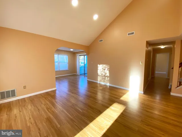 a view of a room with wooden floor