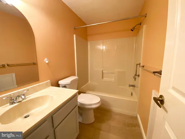 a bathroom with a sink mirror vanity and toilet