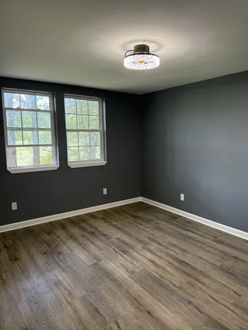 an empty room with a empty space and windows