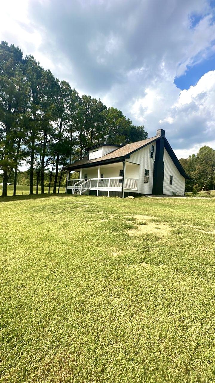 975 Witcher Hollow Road Red Boiling Springs, TN 37150 - Photo 2 of 28 a view of a swimming pool with an outdoor seating and a garden
