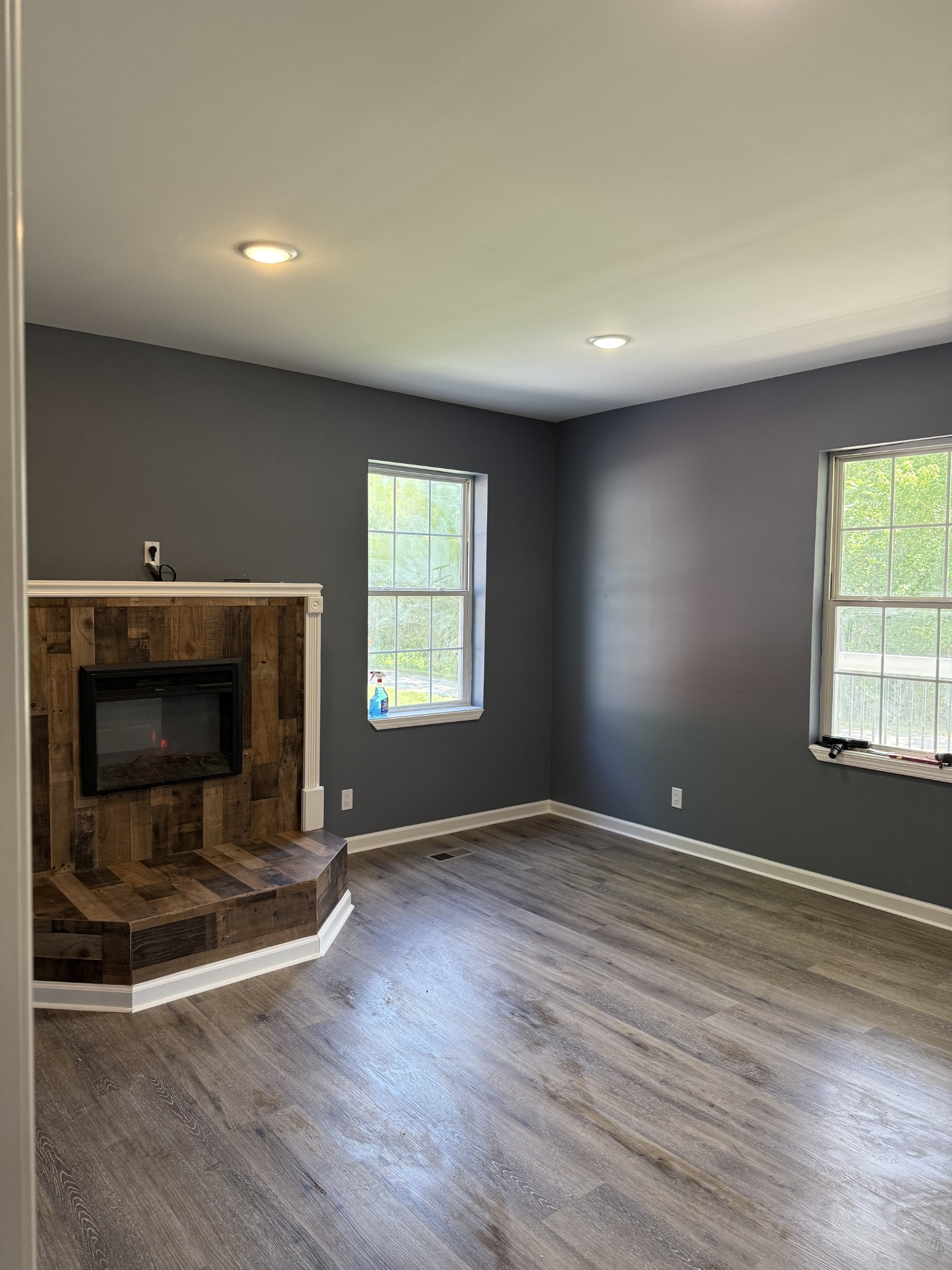 975 Witcher Hollow Road Red Boiling Springs, TN 37150 - Photo 5 of 28 an empty room with wooden floor and fireplace