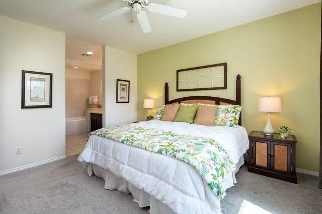 a bedroom with a bed and a lamp