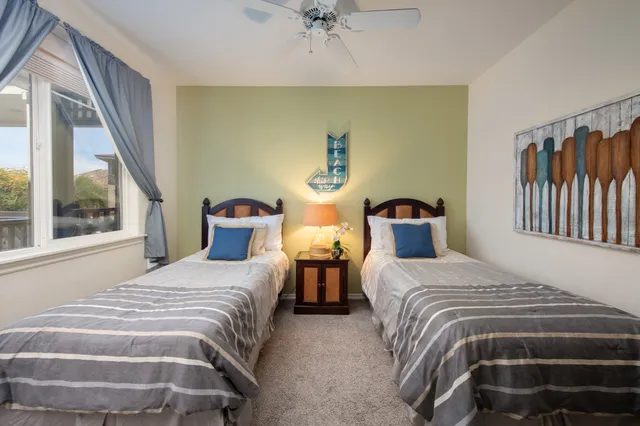 a bedroom with two beds and a window