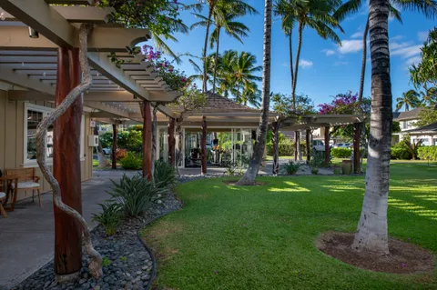 a view of a house with a yard patio and furniture
