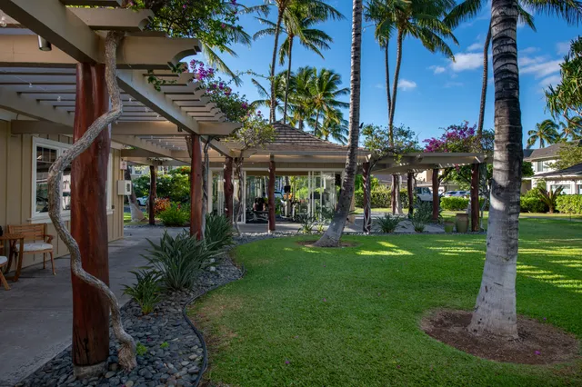 a view of a house with a yard patio and furniture