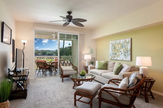 a living room with furniture a chandelier and a large window