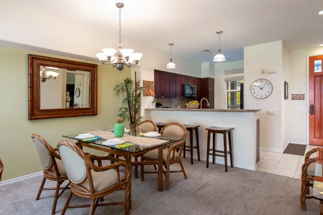 a view of a dining room with furniture and a chandelier